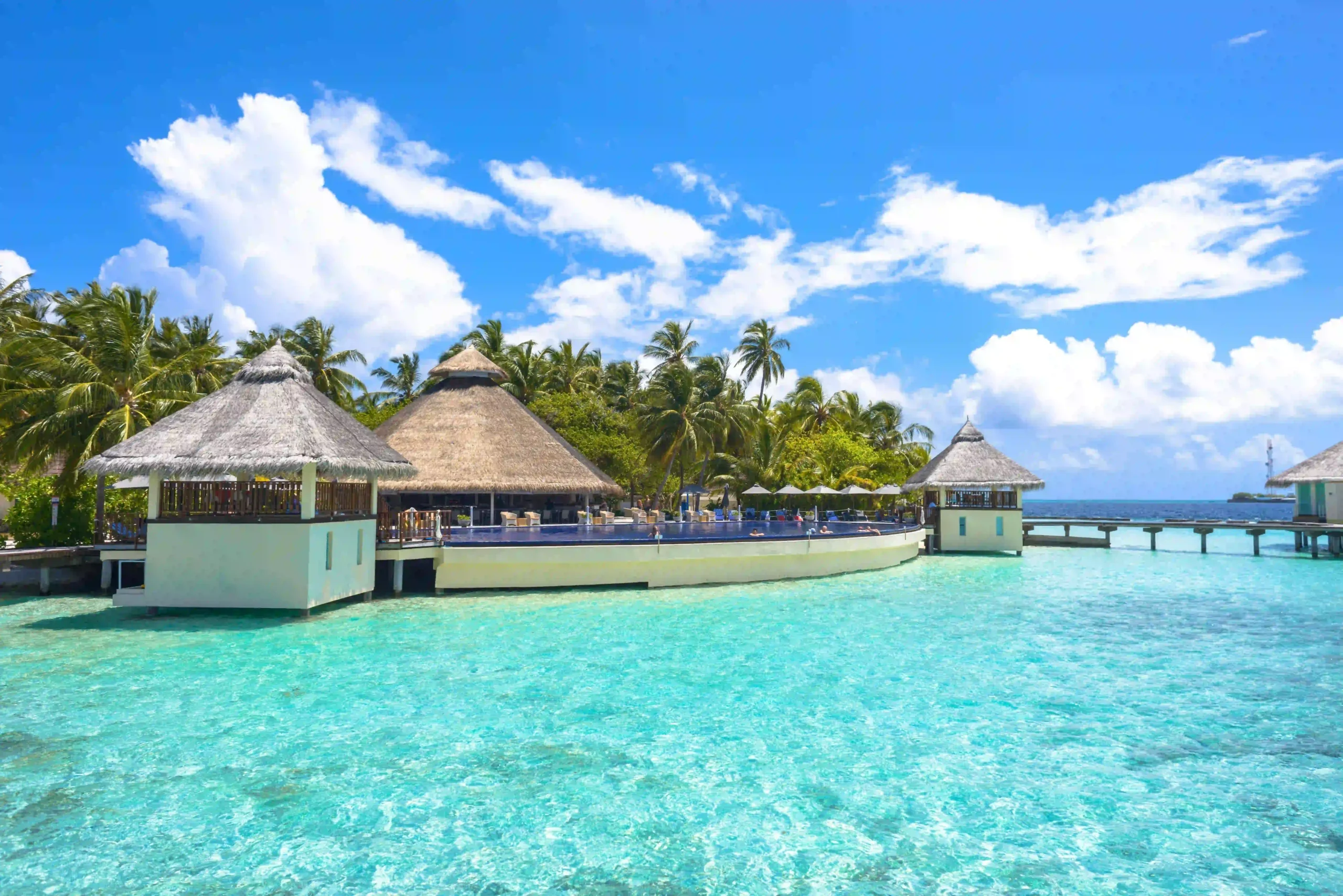 Luxury overwater bungalows in the clear turquoise ocean of the Maldives.