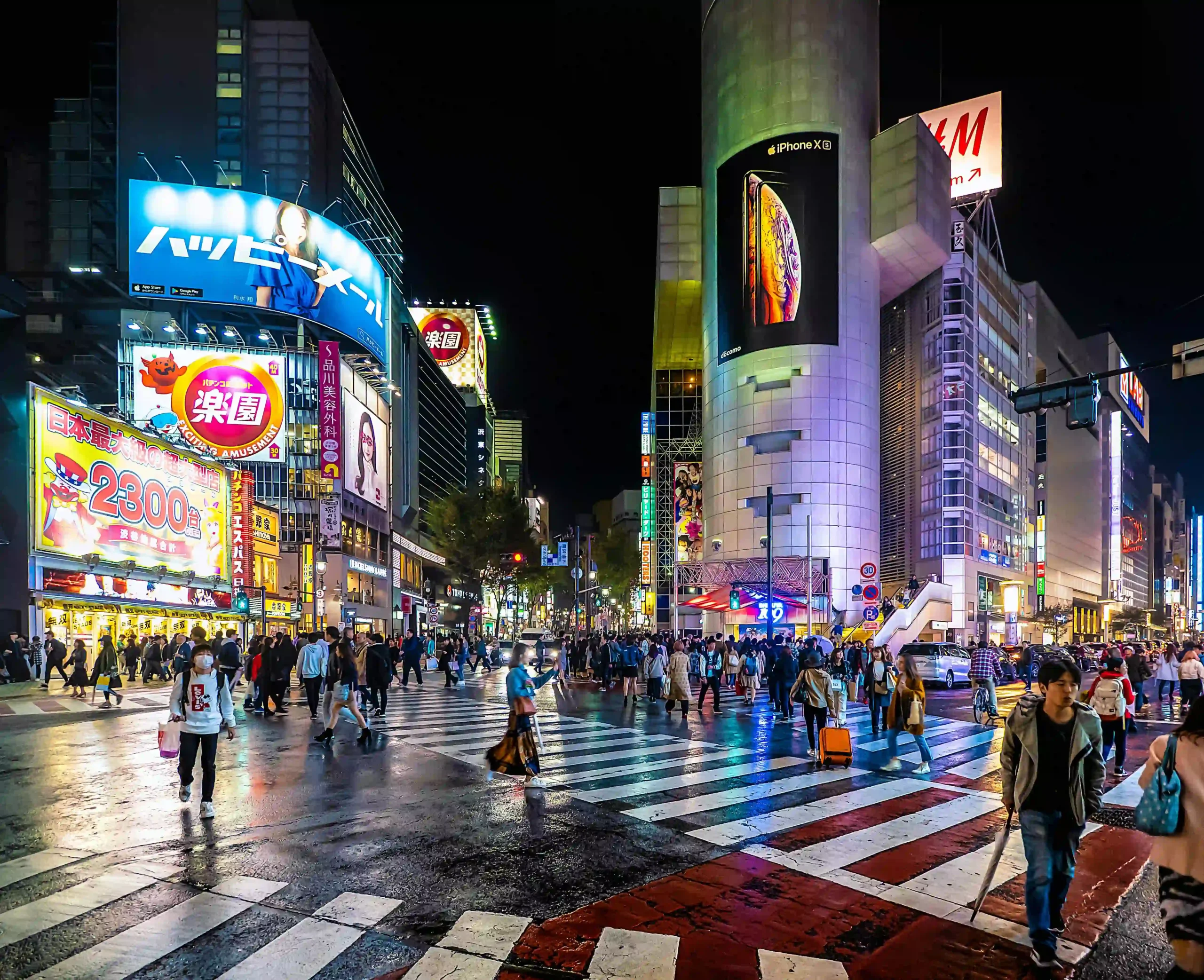 Vibrant neon lights over the bustling Shibuya Crossing in Tokyo at night