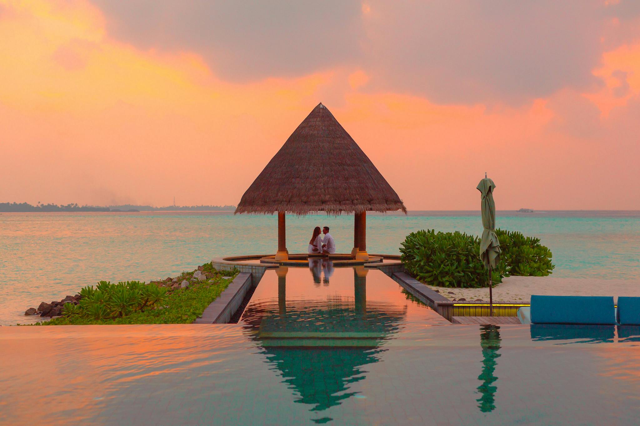 Couple in a romantic cabana at sunset
