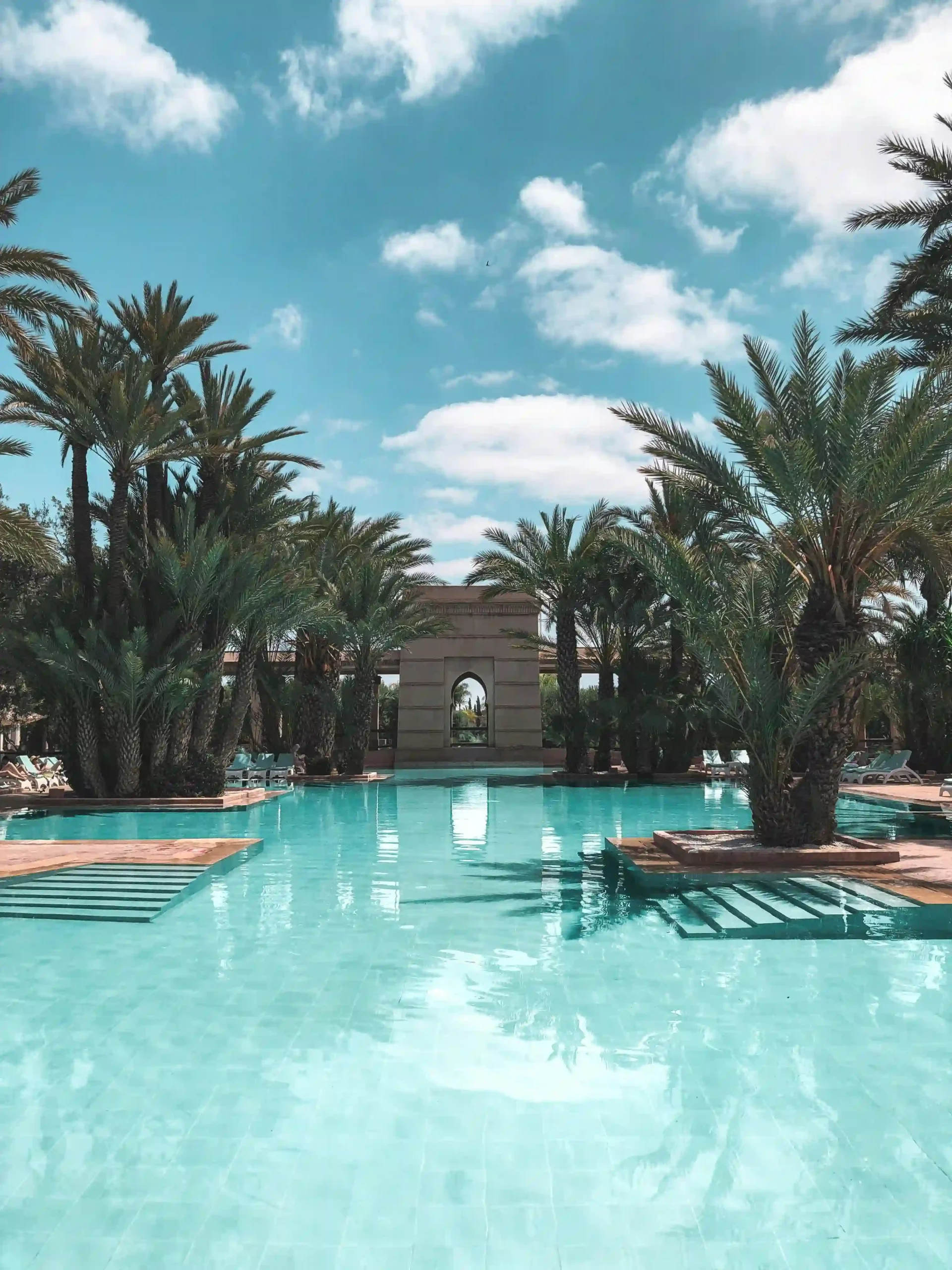 A tranquil, luxurious swimming pool inside a traditional Moroccan riad.