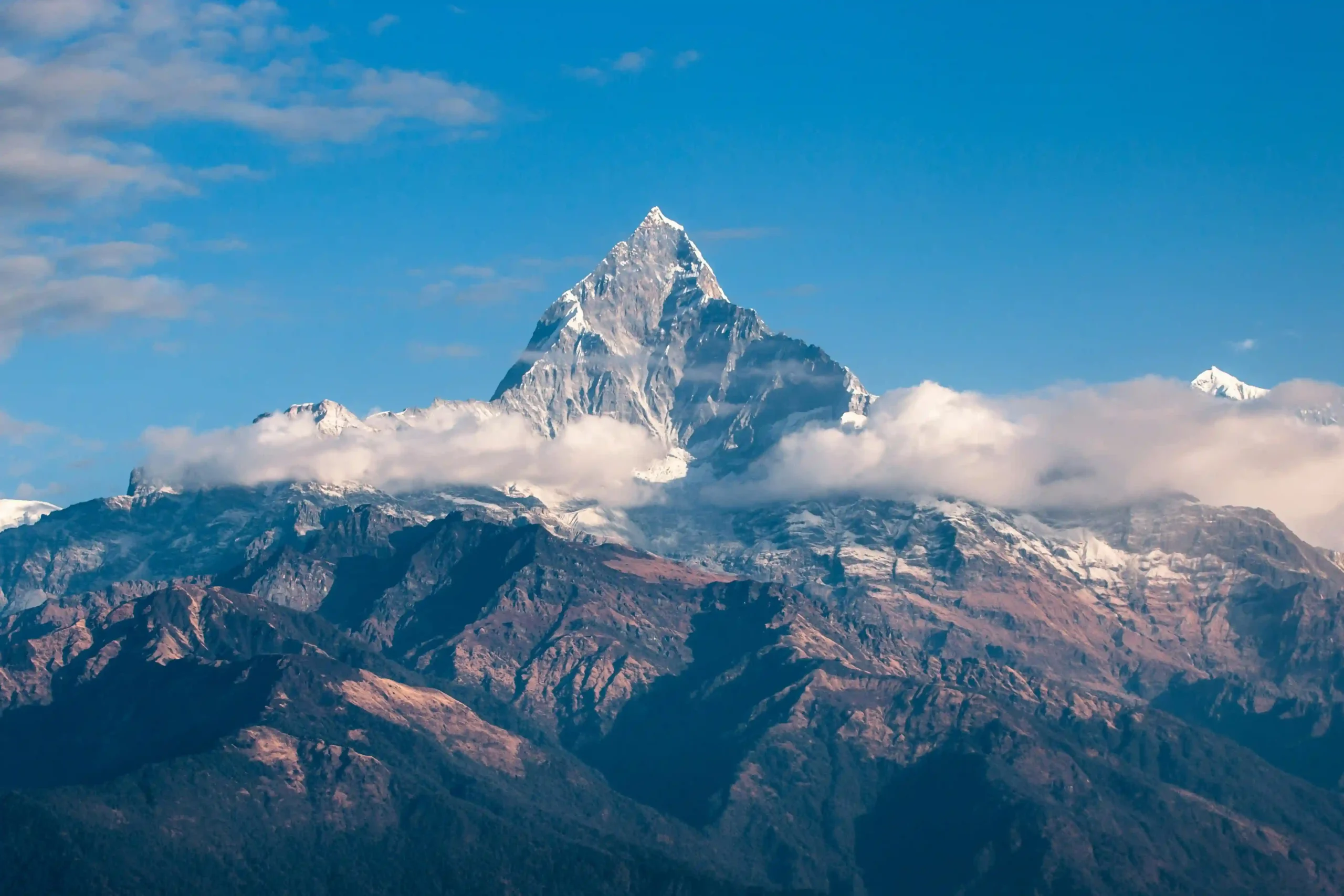 Colorful Buddhist prayer flags with the snow-capped peaks of Mount Everest in the background