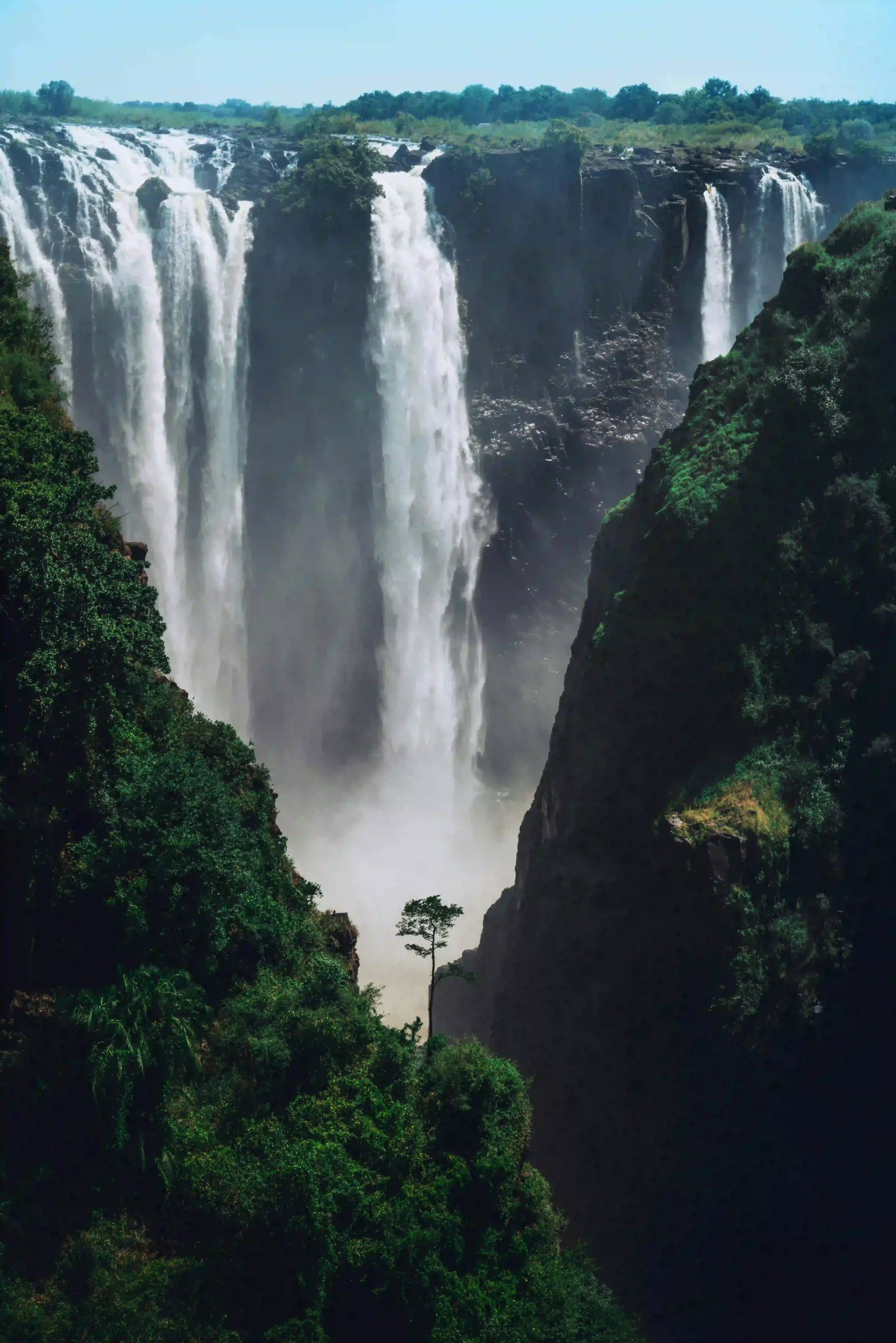 The powerful Victoria Falls with a plume of mist rising high into the air.